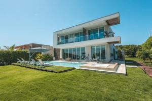 a large house with a swimming pool in the yard at Tropical villa w pool & dock access u501 in Barú