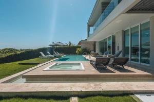 a backyard with a swimming pool and a house at Tropical villa w pool & dock access u501 in Barú +53 photos