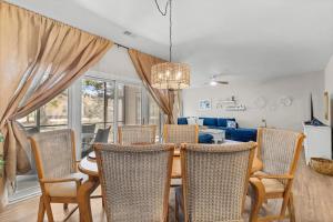a dining room with a table and chairs at Marsh Breeze Hideaway at Masters Place in Pawleys Island