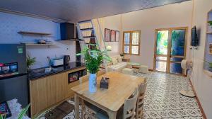 a kitchen and dining room with a wooden table with a plant at AM's Home in Ninh Binh