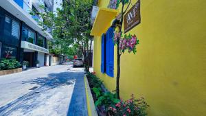 a yellow building with a sign on the side of a street at AM's Home in Ninh Binh