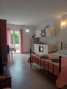 a bedroom with a bed and a kitchen and a room at Studio Apartment Ivo in Cres