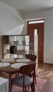 a dining room with a table and four chairs at Mazā Roma in Ventspils