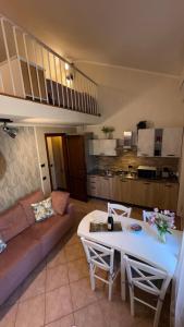 a living room with a couch and a table at Sunset house in Castiglioncello