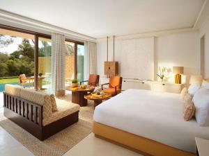 a bedroom with a large bed and a living room at Mandarin Oriental Punta Negra, Mallorca in Palmanova +105 photos