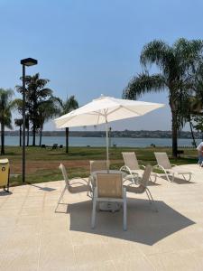 a table and chairs and an umbrella on a patio at Lake view in Brasília