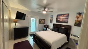 a bedroom with a bed and a flat screen tv at Billy's Resort- Men Only - Solo Hombres in Wilton Manors +35 photos
