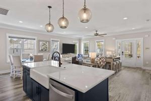 a kitchen and living room of a home at Pool Spa Fire Pit & More at this OKI Escape in Oak Island
