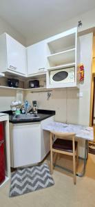 a small kitchen with a sink and a microwave at Avida Towers Aspira Studio Condo in Cagayan de Oro