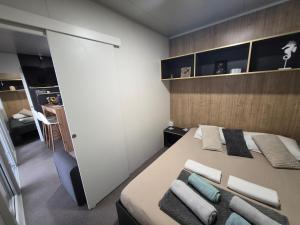 a bedroom with a bed with towels on it at SUNNY Rest Nest in Pakoštane