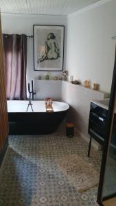 a bathroom with a bath tub and a piano at Le Relais de Belloy in Belloy sur Somme +51 photos