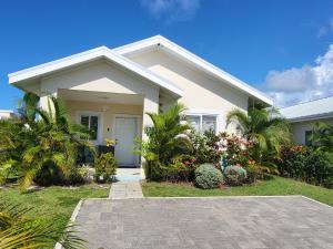 a white house with plants in front of it at Beit Elohim in Lucea
