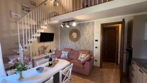 a living room with a couch and a table at Sunset house in Castiglioncello