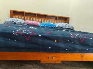 a bed with a blue comforter with stars on it at Samudra Nadi Bliss in Mūlki +13 photos