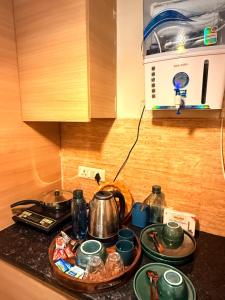 a kitchen counter with a stove with pots and pans at Laugh-Tales in Mathura