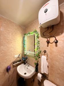 a bathroom with a sink and a mirror at Laugh-Tales in Mathura +31 photos