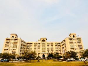 a large apartment building with a park in front of it at Laugh-Tales in Mathura
