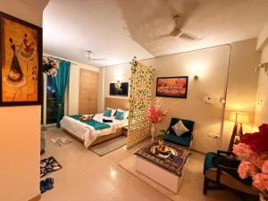 a bedroom with a bed and a living room at Laugh-Tales in Mathura