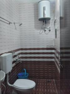 a bathroom with a toilet and a sink and a shower at Samudra Nadi Bliss in Mūlki