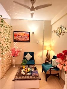 a living room with a chair and a table at Laugh-Tales in Mathura