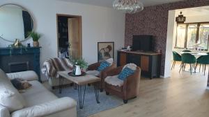 a living room with a couch and chairs and a table at Le Relais de Belloy in Belloy sur Somme