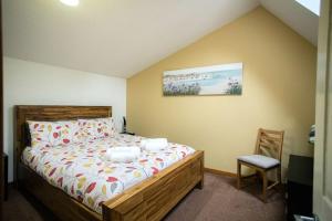 a bedroom with a bed and a chair in it at 52a Albert Street in Kirkwall