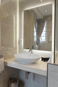 a bathroom with a white sink and a mirror at Altes Zollhaus in Beilstein +42 photos