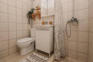 a bathroom with a toilet and a sink and a shower at Tonella Studio in Corfu +6 photos