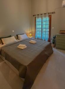 a large bed with two towels on top of it at Aria Seaview Villa in Vourvourou