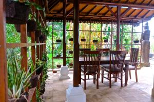 a wooden table and chairs on a patio at Villa Boreh Beach Resort and Spa in Tejakula