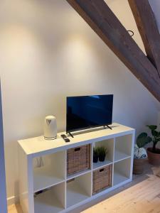 a white cabinet with a tv on top of it at Annasroom in Kortrijk