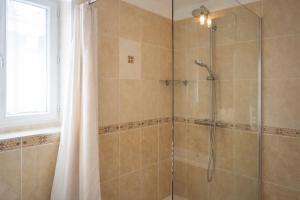a bathroom with a shower with a glass door at L'Harmony in Saint-Arnoult-en-Yvelines