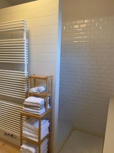 a bathroom with a stack of folded towels at Annasroom in Kortrijk