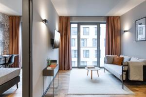 a living room with a couch and a table at ipartment Darmstadt HOME by Best Western in Darmstadt