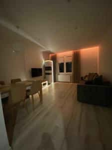 a living room with a couch and a table and chairs at Apartament DeLux WHITE Konin in Konin