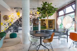 a room with a table and chairs and a staircase at ipartment Berlin Airport HOME by Best Western in Schönefeld