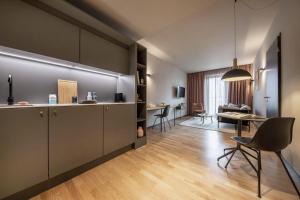 a kitchen and living room with a table and chairs at ipartment Berlin Airport HOME by Best Western in Schönefeld