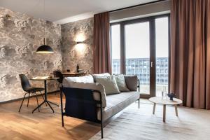 a living room with a couch and a table at ipartment Berlin Airport HOME by Best Western in Schönefeld