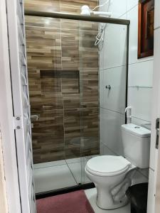 a bathroom with a toilet and a glass shower at Suítes Maanaim Flecheiras in Flecheiras +10 photos