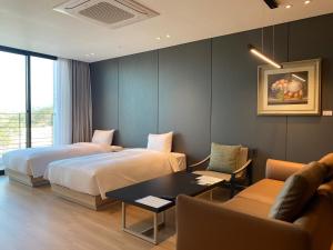 a hotel room with two beds and a table at ILLITE Hotel in Yŏngdong +22 photos