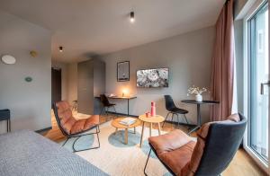 a living room with a couch and chairs and a table at ipartment Braunschweig HOME by Best Western in Braunschweig