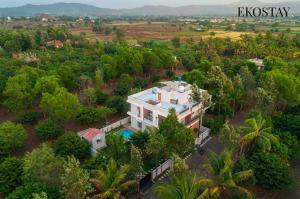 an aerial view of a house in the middle of a forest at EKOSTAY Gold - Vanamora Villa in Pandhurli