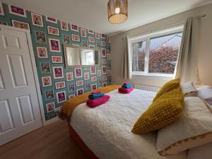 a bedroom with a bed with some pillows on it at Stillrovin Cottage in Stirling