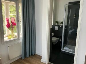 a bathroom with a toilet and a window at VillaWie in Rheda-Wiedenbrück +212 photos