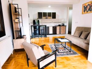 a living room with a couch and a table at Hera Sweet Apartment in Niš