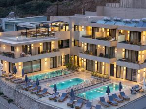 an aerial view of a building with a swimming pool at Celeste Bali Suites in Bali