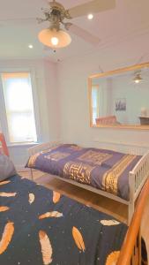 a bedroom with a bed and a mirror at Meadow room in Slough