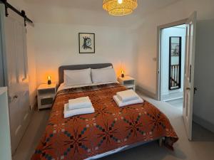 a bedroom with a bed with two pillows on it at Ty Mawr Farm in Llanfairpwllgwyngyll