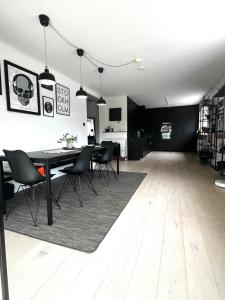 a living room with a dining room table and chairs at Villa med Pool in Stockholm