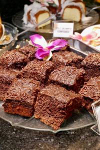 a bunch of brownies on a plate on a table at Lapônia Hotel Gramado in Gramado